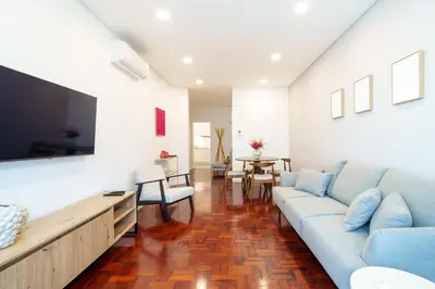 a living room with a couch and a flat screen tv at Carmo Downtown Apartment by Amazing Madeira in Funchal