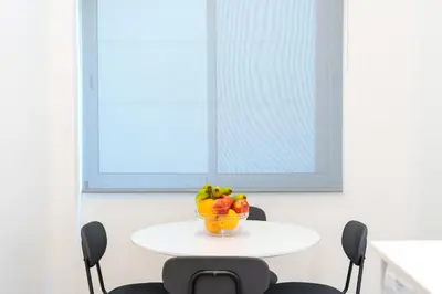 a table with a bowl of fruit on it at Carmo Downtown Apartment by Amazing Madeira in Funchal