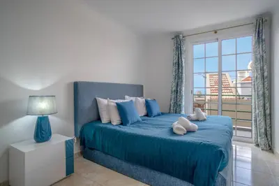 a bedroom with a large bed with towels on it at Villa Alegra Paul do Mar in Paul do Mar