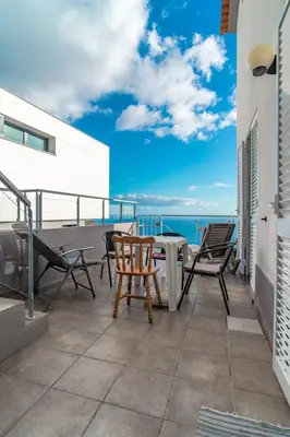 a shower with a glass door in a bathroom at Villa Casanova in Arco da Calheta