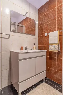 a bedroom with a bed and a dresser and a mirror at Villa Casanova in Arco da Calheta
