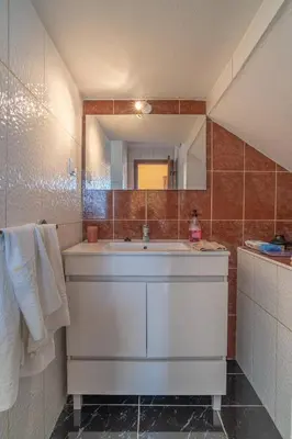a bathroom with a sink and a mirror at Villa Casanova in Arco da Calheta