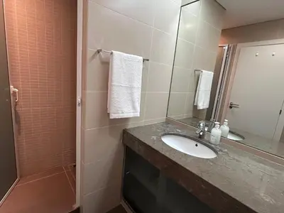 a bathroom with a sink and a shower with a mirror at Ocean Sea View Apartment in Funchal