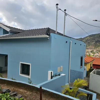 a blue house with a black roof at JoLi Larano - APT with 3 bedroom and 2 wc in Machico