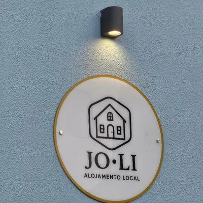 a sign on a wall with a building on it at JoLi Larano - APT with 3 bedroom and 2 wc in Machico