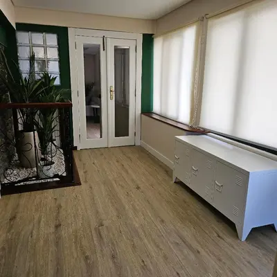 an empty room with a desk and windows at JoLi Larano - APT with 3 bedroom and 2 wc in Machico