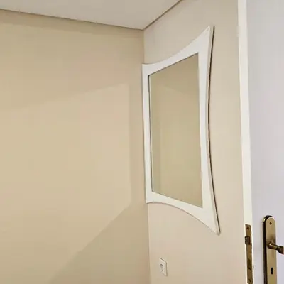 a mirror on a wall next to a door at JoLi Larano - APT with 3 bedroom and 2 wc in Machico