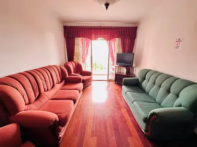 a living room with couches and a television at Lido Funchal in Funchal