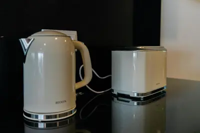 two coffee machines sitting next to each other on a table at Sea View Apartment in Caniço