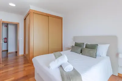 a bedroom with a white bed with towels on it at Sea View Apartment in Caniço