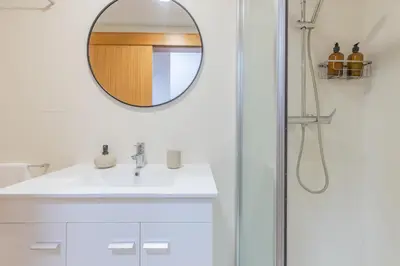 a bathroom with a sink and a mirror at Sea View Apartment in Caniço
