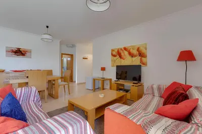 a living room with two couches and a table at Beachside oasis with Pool in Luz