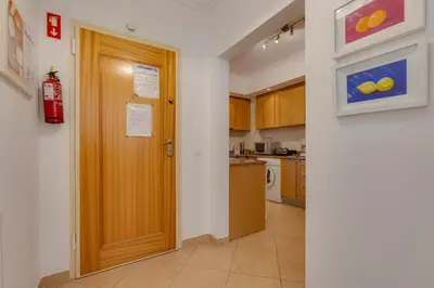 a hallway with a wooden door in a kitchen at Beachside oasis with Pool in Luz