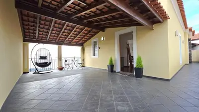 an outdoor patio with a chair on a building at Casa Amarela - Estreito de Câmara de Lobos in Estreito de Câmara de Lobos