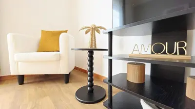 a living room with a chair and a table at Casa Amarela - Estreito de Câmara de Lobos in Estreito de Câmara de Lobos