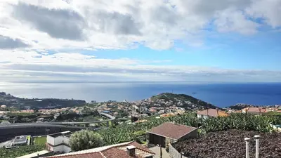 a view of a town with the ocean in the background at Casa Amarela - Estreito de Câmara de Lobos in Estreito de Câmara de Lobos