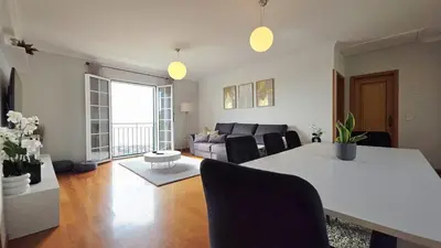 a living room with a table and a couch at Casa Amarela - Estreito de Câmara de Lobos in Estreito de Câmara de Lobos