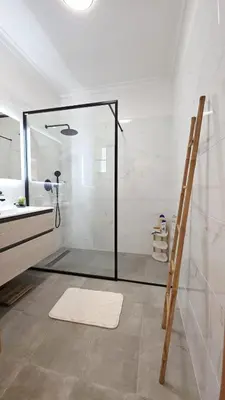 a bathroom with a shower with a glass door at Casa Amarela - Estreito de Câmara de Lobos in Estreito de Câmara de Lobos