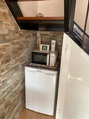 a microwave sitting on top of a refrigerator in a kitchen at Vista Clara in Ponta do Sol