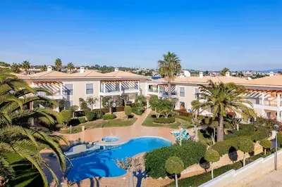 an aerial view of a resort with a pool and palm trees at Apartamento Solmar in Lagos