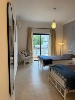 a bedroom with two beds and a mirror at Apartamento Solmar in Lagos