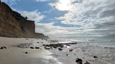 a beach with rocks and the ocean on a cloudy day at Apartamento Solmar in Lagos