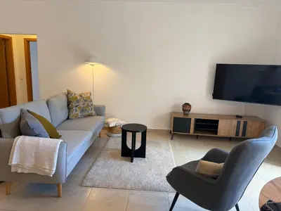a living room with a couch and a tv at Apartamento Solmar in Lagos