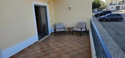 two chairs and a table on the balcony of a building at Apartamento Solmar in Lagos