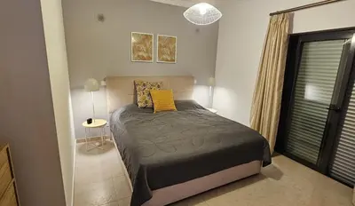 a bedroom with a bed and a window at Apartamento Solmar in Lagos