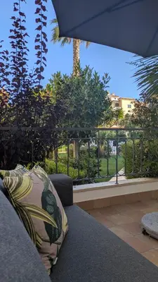 a couch with a pillow sitting on top of a patio at Apartamento Solmar in Lagos