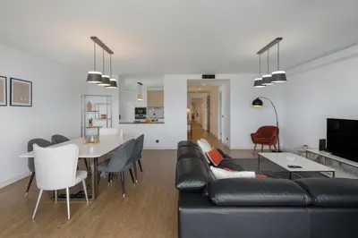 a living room with a black couch and a table at Apartamento São Lucas I by An Island Apart in Funchal