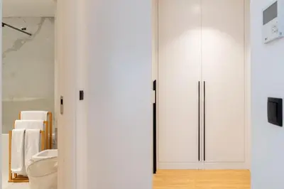 a bathroom with white cabinets and a toilet at Apartamento São Lucas I by An Island Apart in Funchal