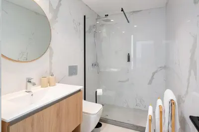 a bathroom with a shower and a sink and a toilet at Apartamento São Lucas I by An Island Apart in Funchal