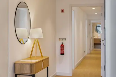 a hallway with a mirror and a table with a lamp at Apartamento São Lucas I by An Island Apart in Funchal