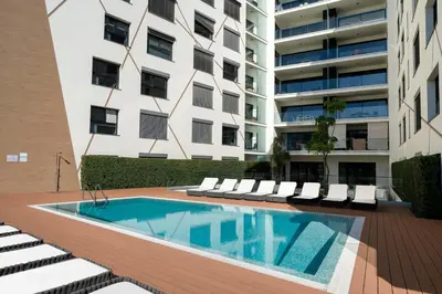 a swimming pool in front of a building at Apartamento São Lucas I by An Island Apart in Funchal