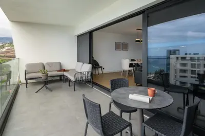 a living room with a table and chairs at Apartamento São Lucas I by An Island Apart in Funchal