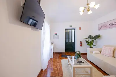 a living room with a couch and a tv on a wall at Peaceful Panorama by YOUR KEY MADEIRA in Porto Moniz
