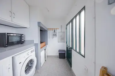 a laundry room with a washing machine and a window at Peaceful Panorama by YOUR KEY MADEIRA in Porto Moniz