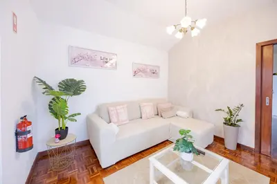 a living room with a white couch and potted plants at Peaceful Panorama by YOUR KEY MADEIRA in Porto Moniz