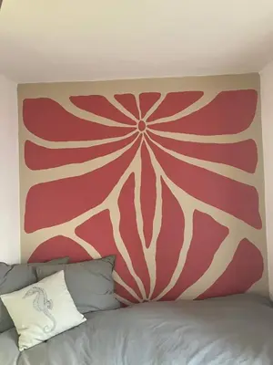 a painting on a wall above a bed at Ocean Retreat in Fajã da Ovelha