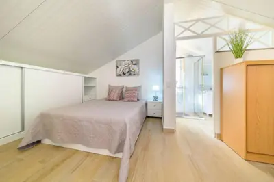 a bedroom with a bed in a white room at Camarata Flat by Mth in Campanário