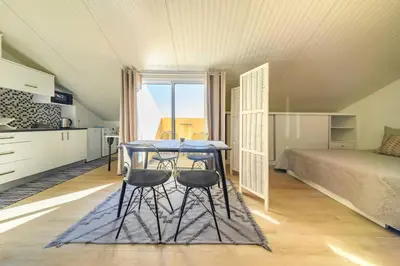a room with a table and two chairs and a bed at Camarata Flat by Mth in Campanário
