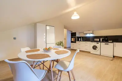 a kitchen and dining room with a table and chairs at Casa Fontes in Canhas