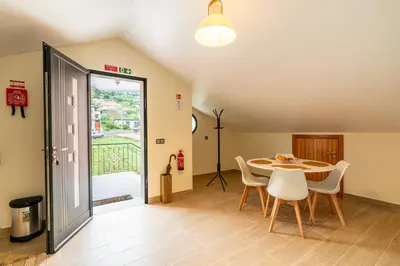 a dining room with a table and chairs at Casa Fontes in Canhas
