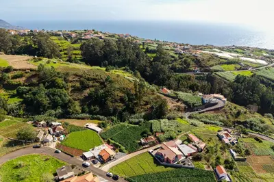 an aerial view of a house on a hill next to the ocean at Casa Fontes in Canhas