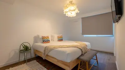 a bedroom with a bed and a chandelier at Casa do Xano I by LovelyStay in Câmara de Lobos