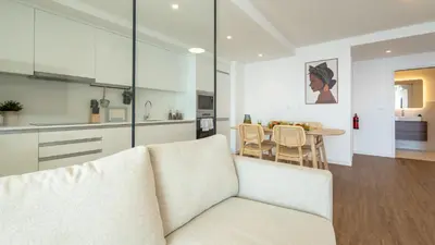 a white living room with a couch and a table at Casa do Xano I by LovelyStay in Câmara de Lobos