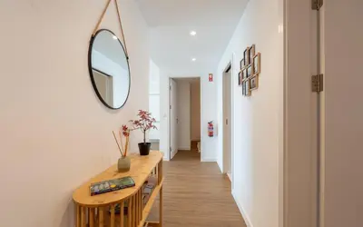a hallway with a mirror and a wooden table at Casa do Xano I by LovelyStay in Câmara de Lobos