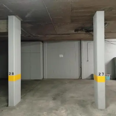 an empty garage with white walls and white columns at Varandas do Funchal Apartment in Funchal