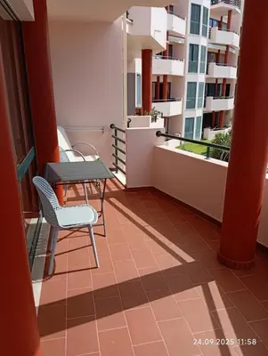 a balcony of a apartment with a table and chairs at Varandas do Funchal Apartment in Funchal